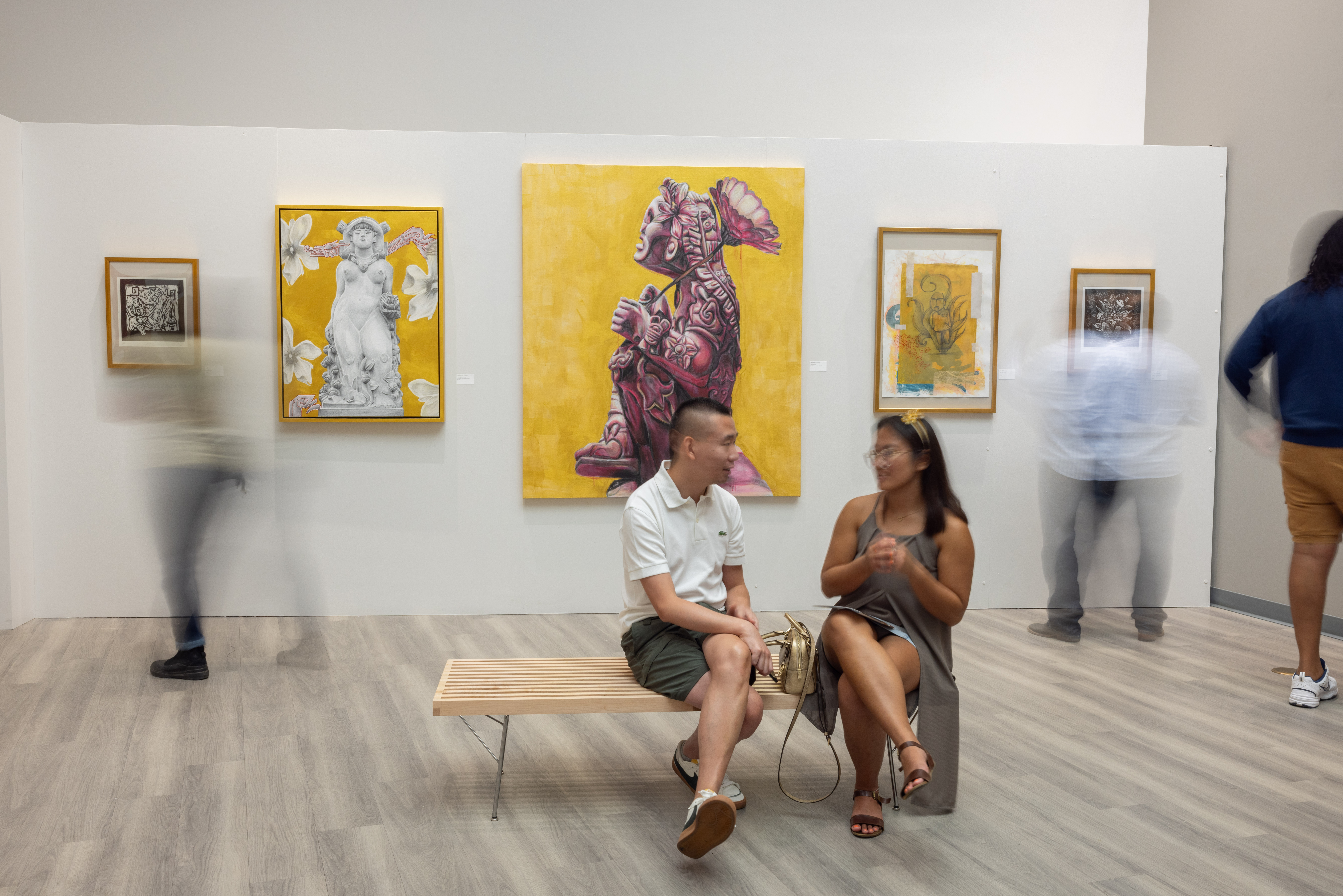 Patrons sitting in the gallery