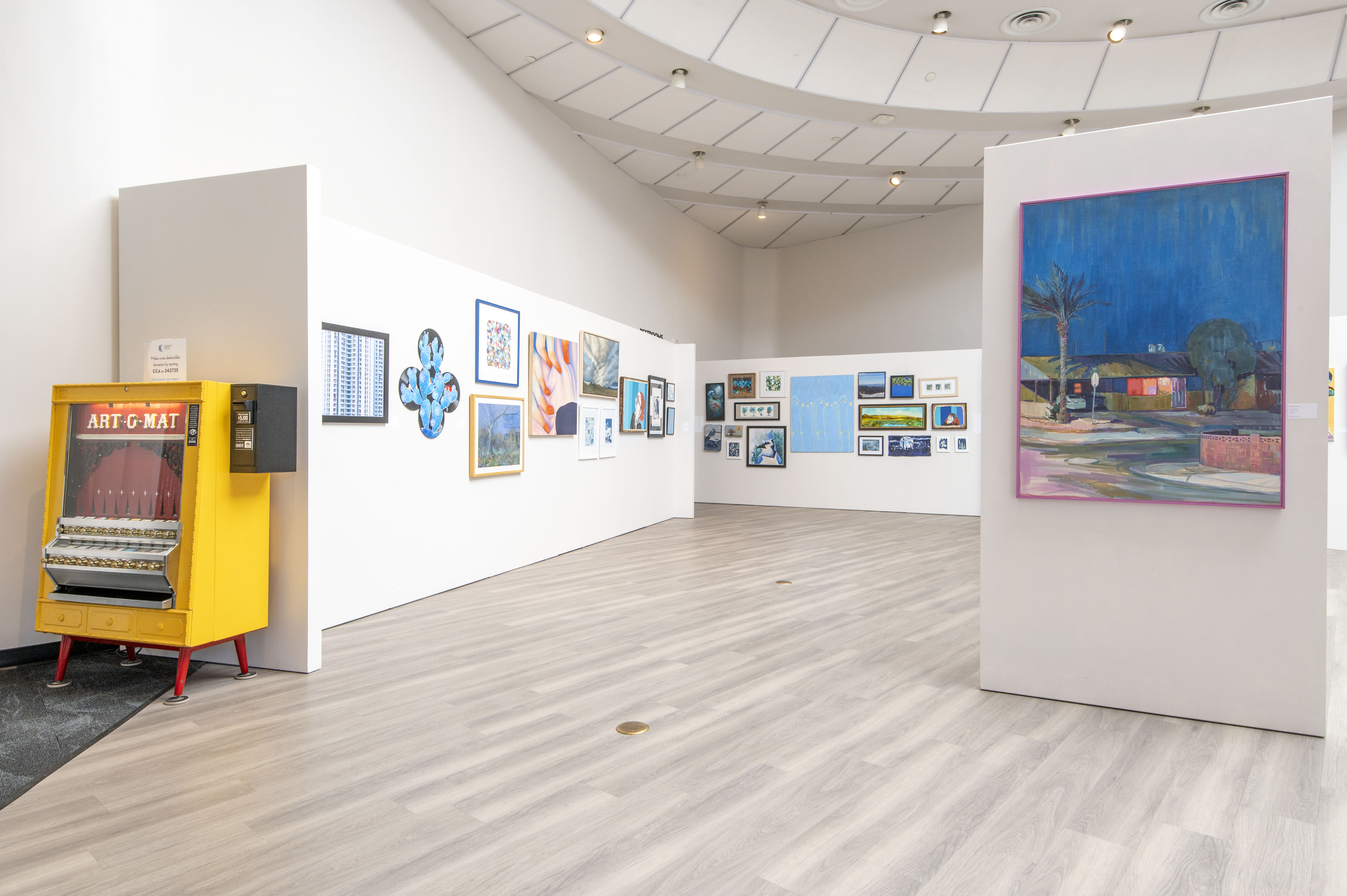 the gallery is empty of people, but full of art