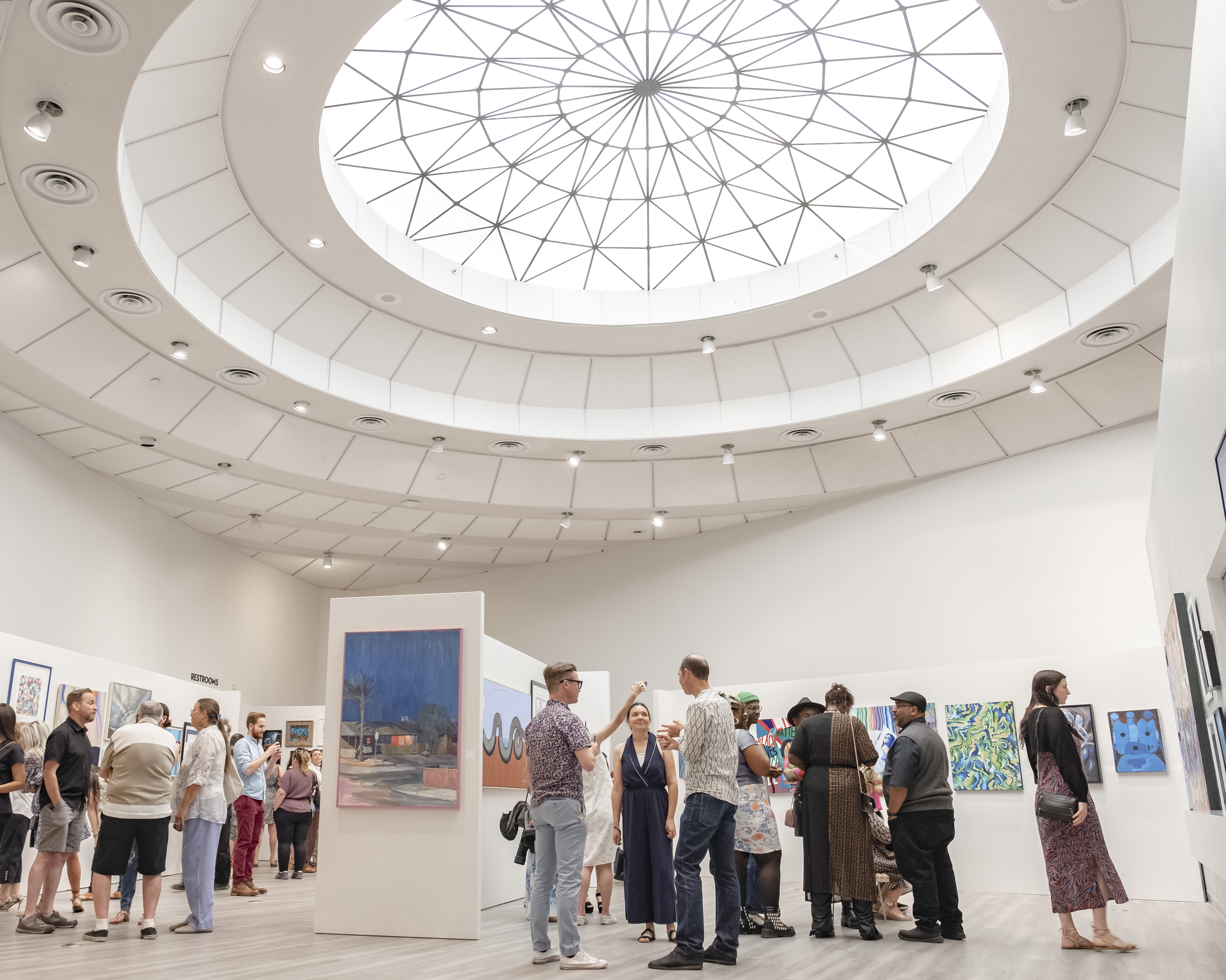 Patrons standing in the gallery