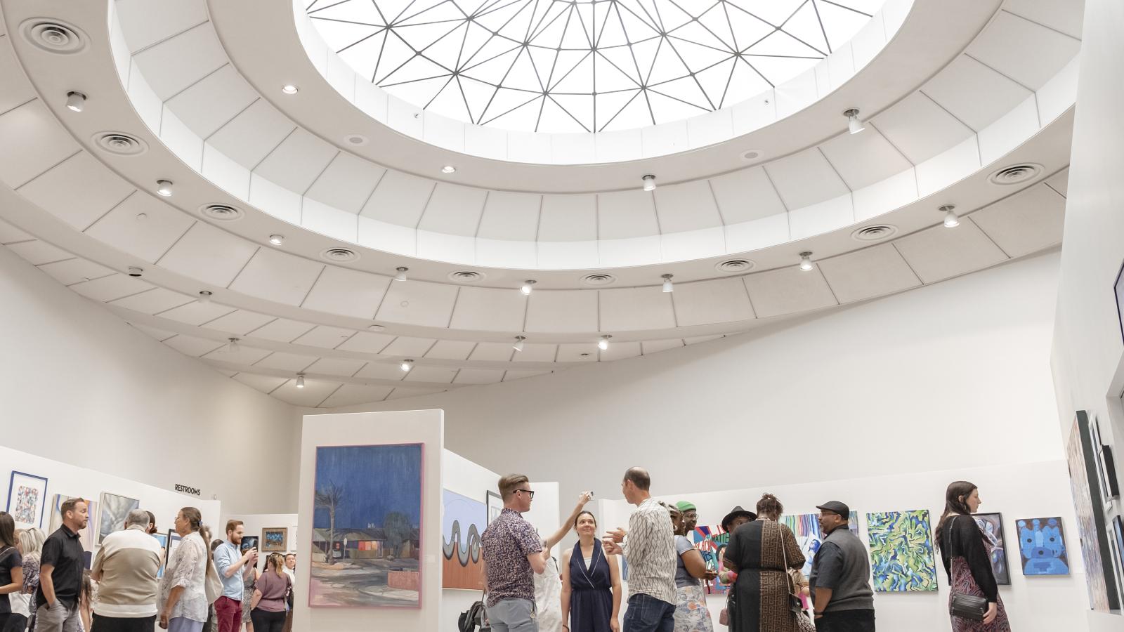Patrons standing in the gallery