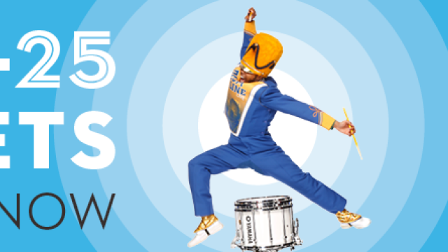 A drum major is mid-jump in the middle of a blue background