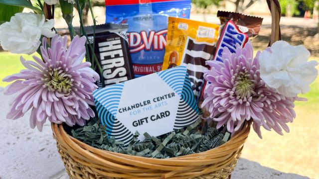 CCA gift card sitting in a basket along with flowers and candy.