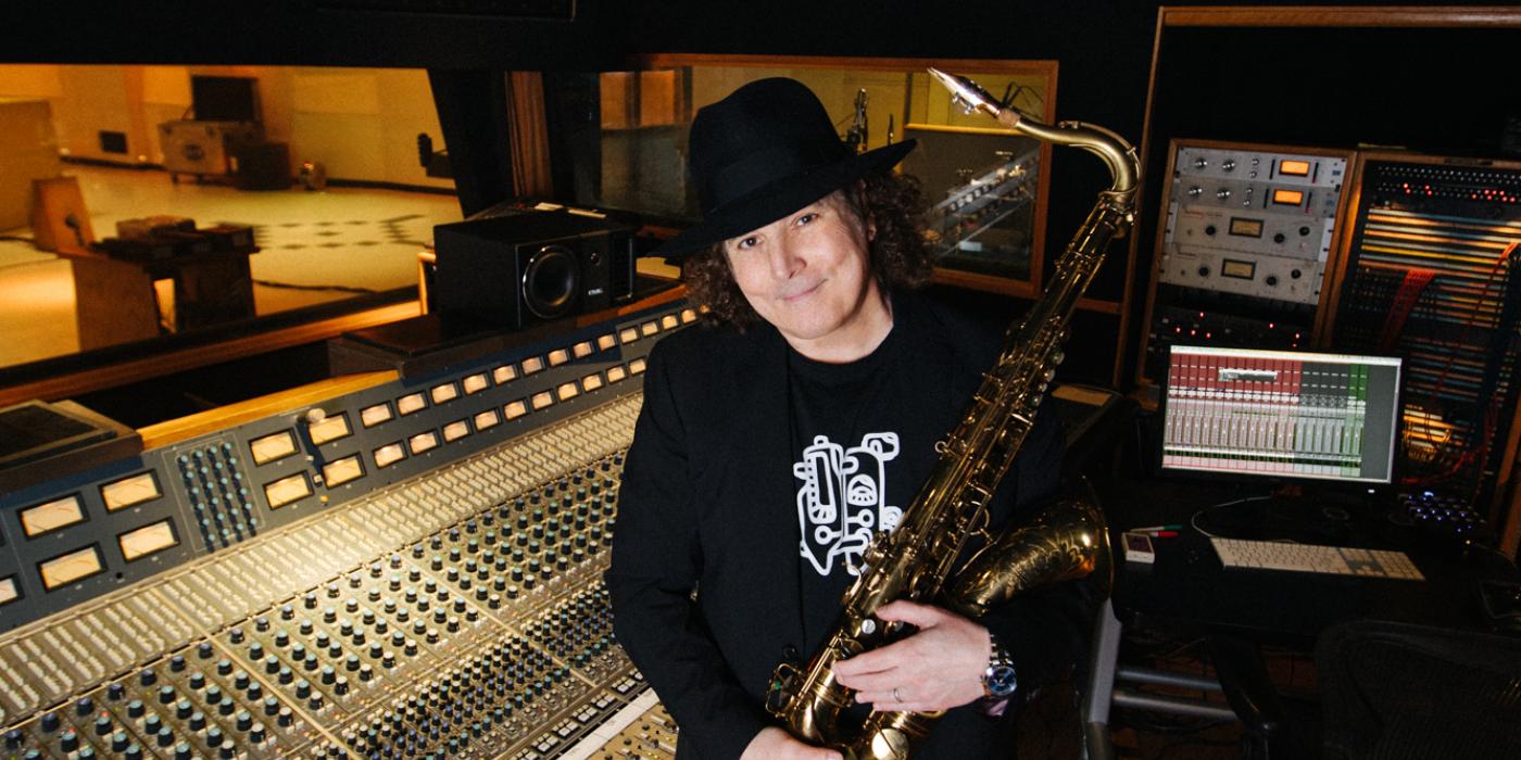 boney james stands in the recording studio with his saxophone