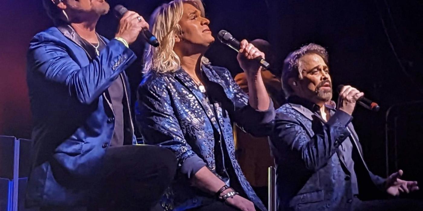 The Texas Tenors singing on stage with blue/dark background