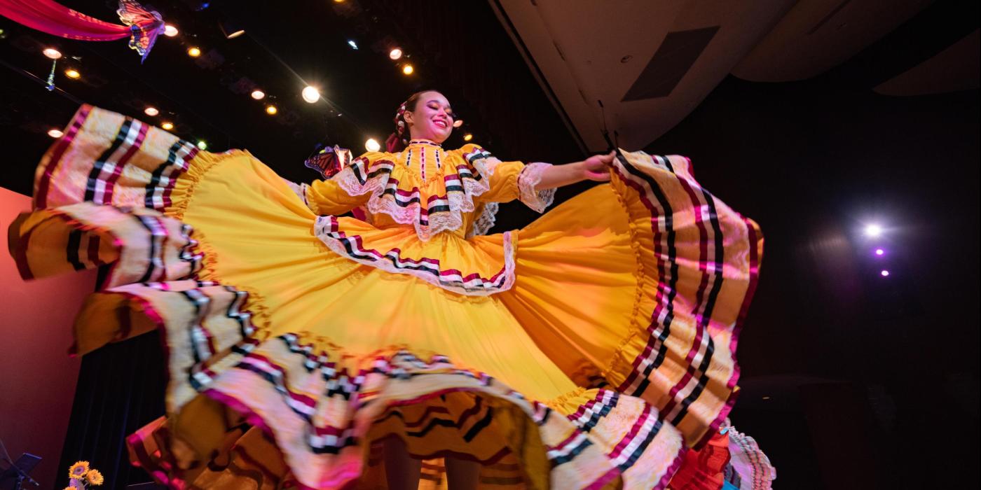 Folklorico dancer with spinning yellow dress