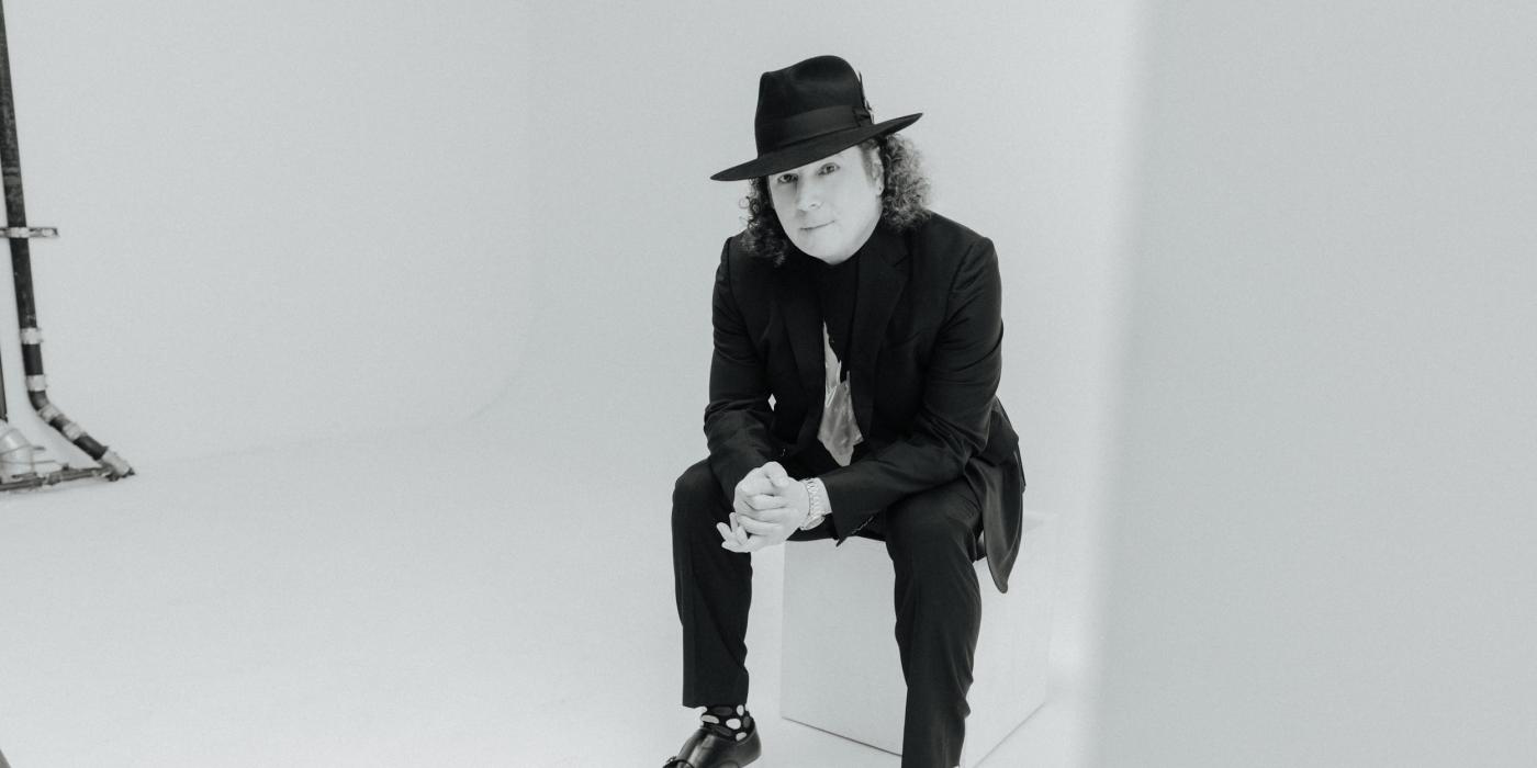 Boney James sitting with black and white edit