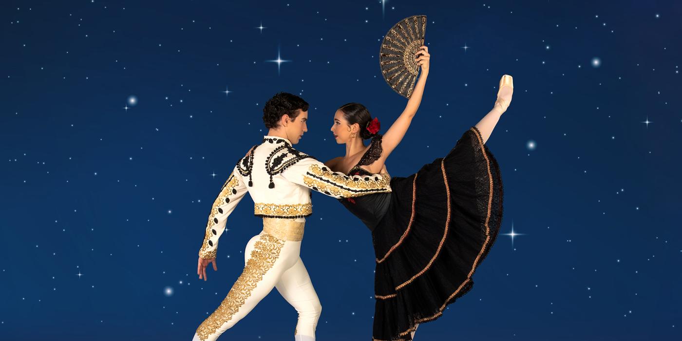 a man and woman dance against a night sky