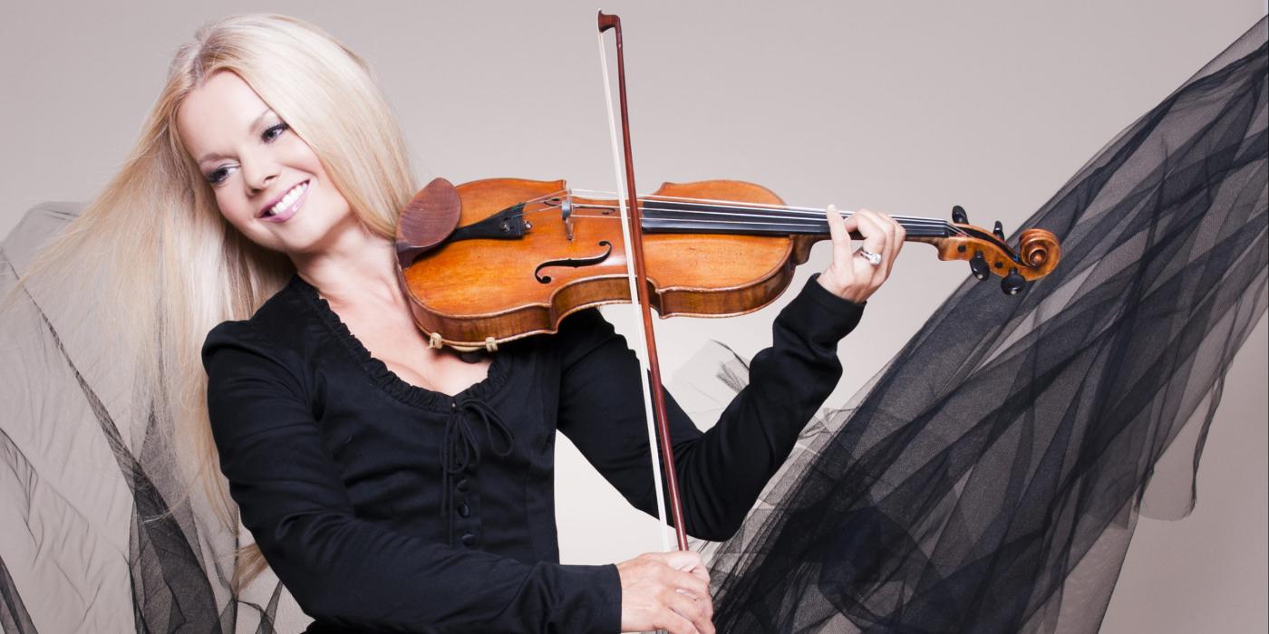 Woman in black tulle dress playing violin dressed