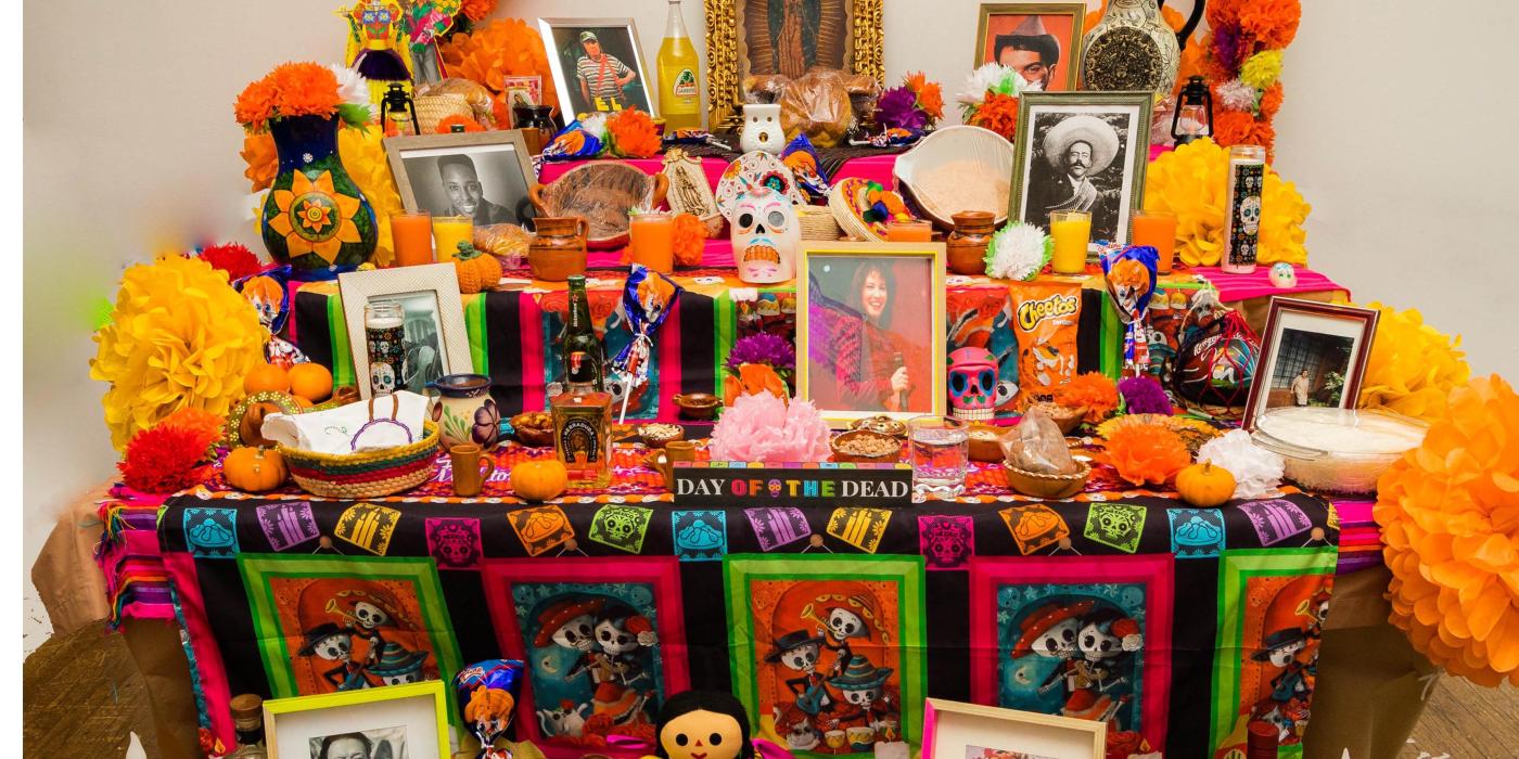 Community altar laden with photos and treats.