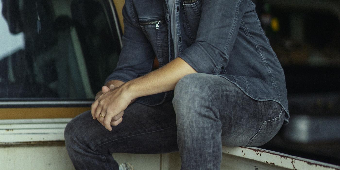 Scotty McCreery sitting in a truck bed
