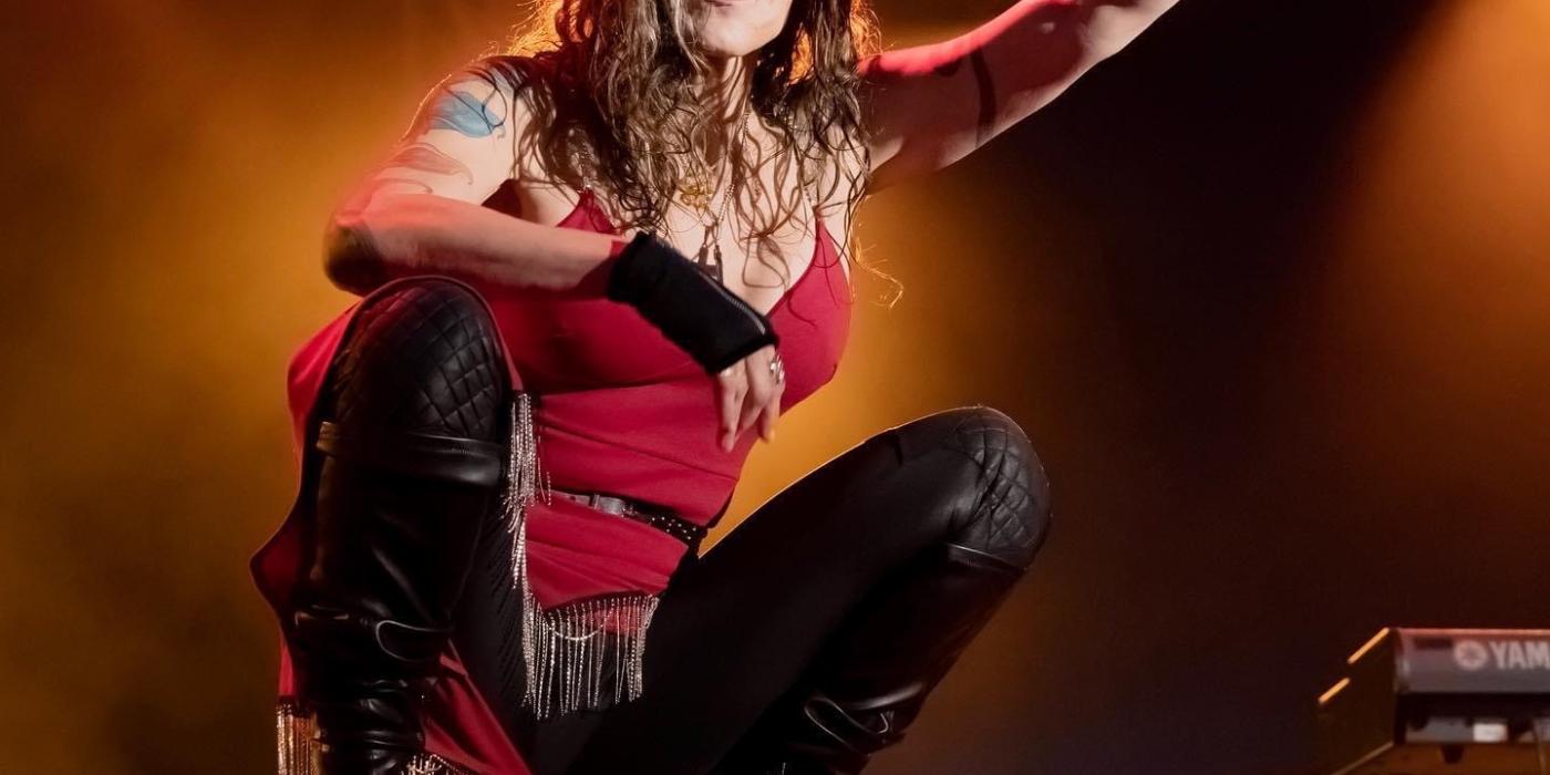 Beth Hart wearing a red tank top and black leather pants