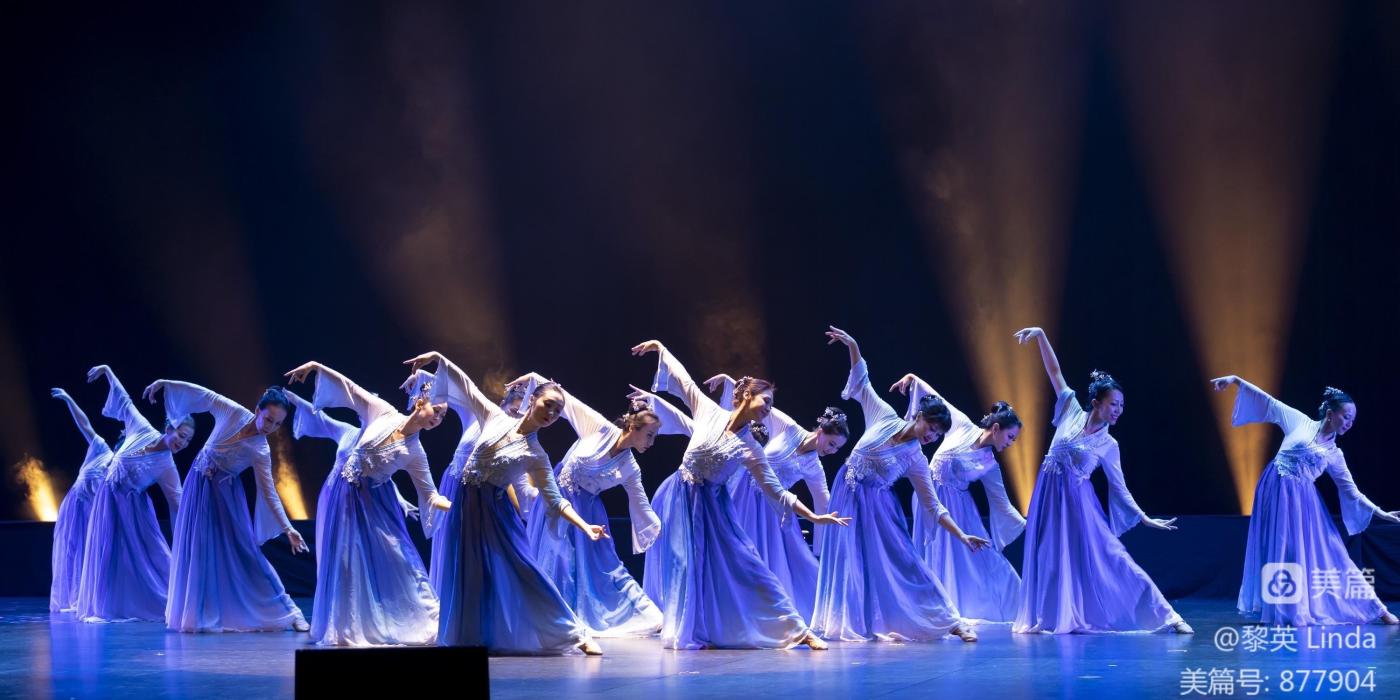Spring Festival Gala group of female dancers on stage lit with blue light