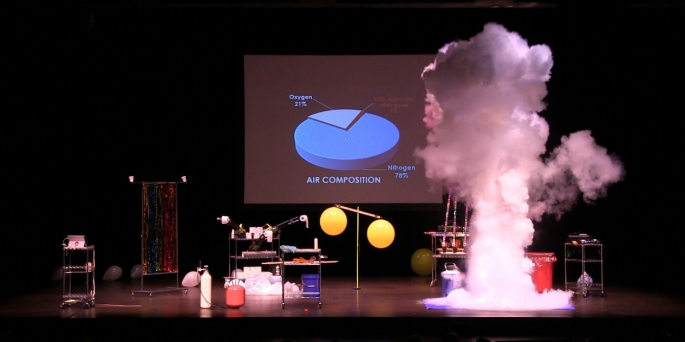 pie char of air composition on screen with smoke and other science related materials on stage