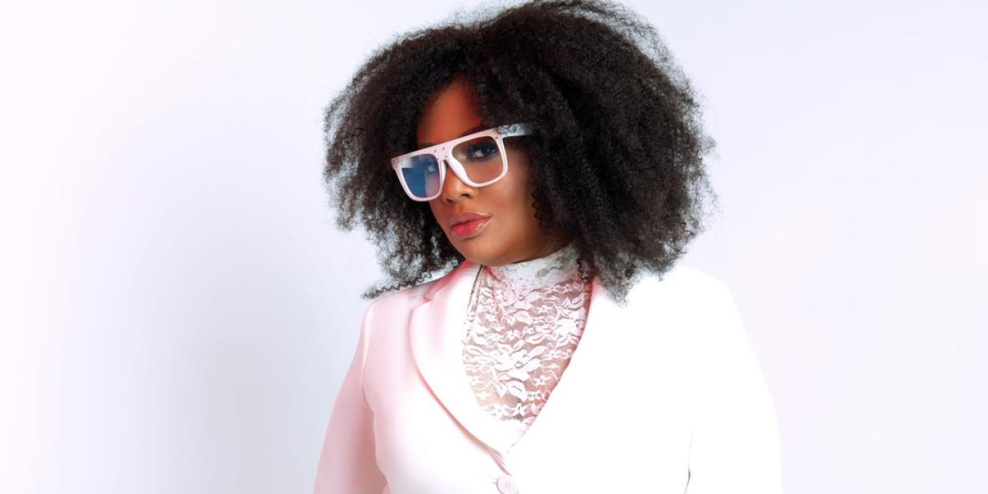 Lalah Hathaway wearing a white suit