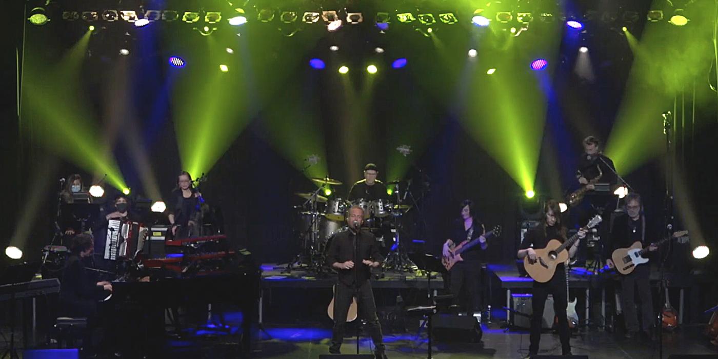 Musicians on stage lit with dramatic green lights