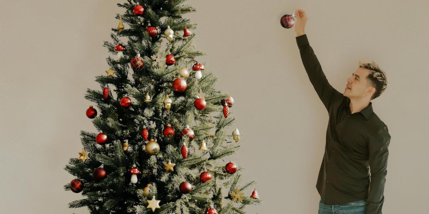 David Archuleta decorating a Christmas tree.