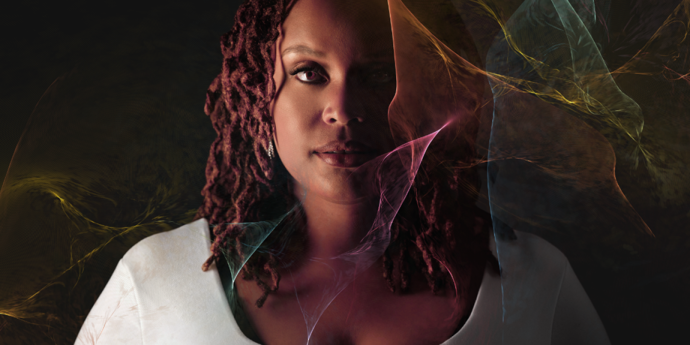 Woman with half her face in shadow and colorful smoke-like texture