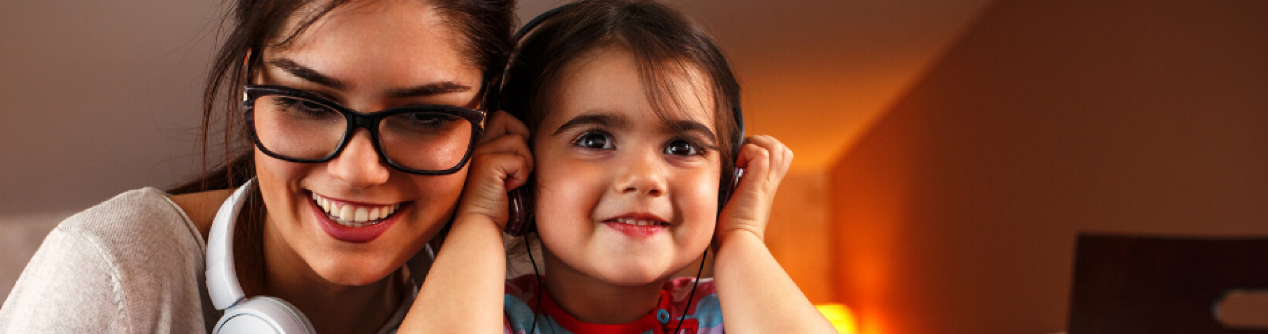A mother and daughter engaging in an onscreen activity