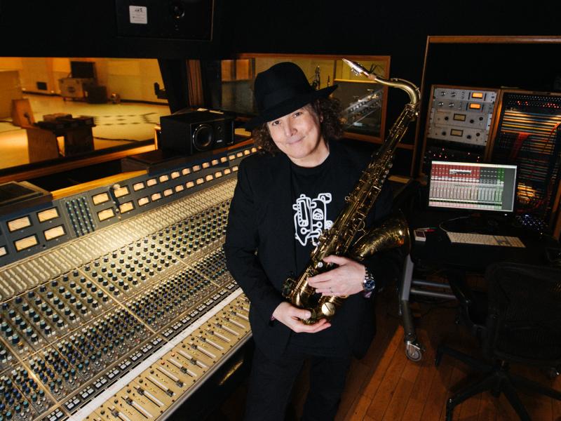 boney james stands in the recording studio with his saxophone
