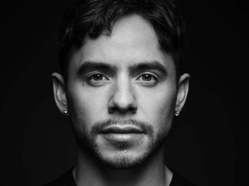 Black and white photo of a male. 