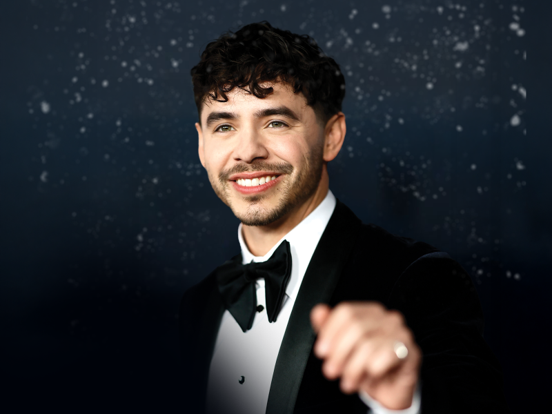David Archuleta in a black tux, smiling against a snowy backdrop