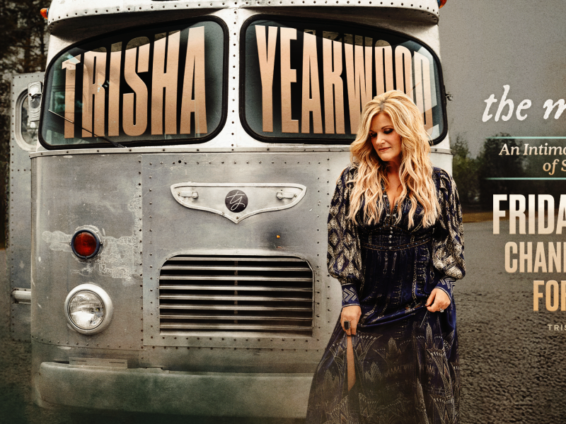 Blonde woman standing in front of silver van/bus