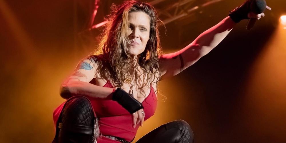 Beth Hart wearing a red tank top and black leather pants
