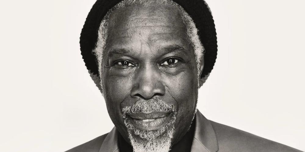 Black and white photo of Billy Ocean wearing a hat