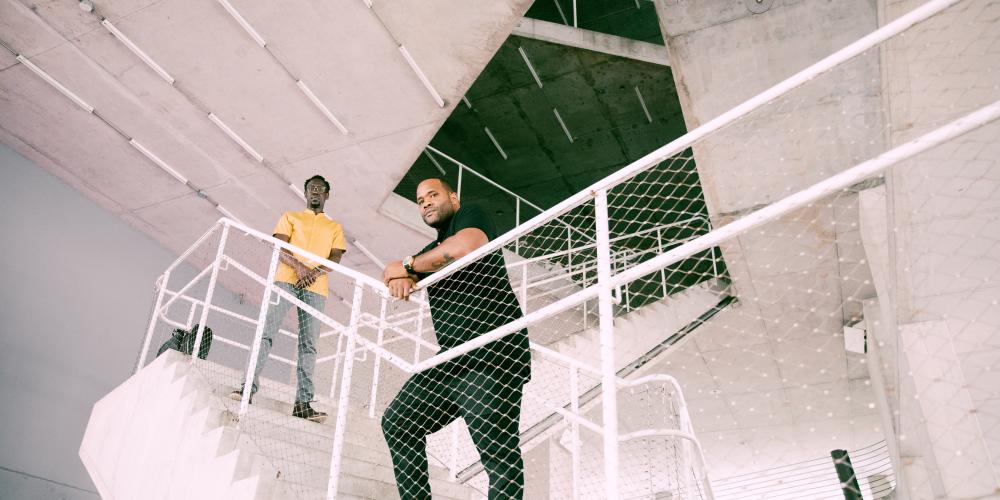 Members of Black Violin posing on the stairwell