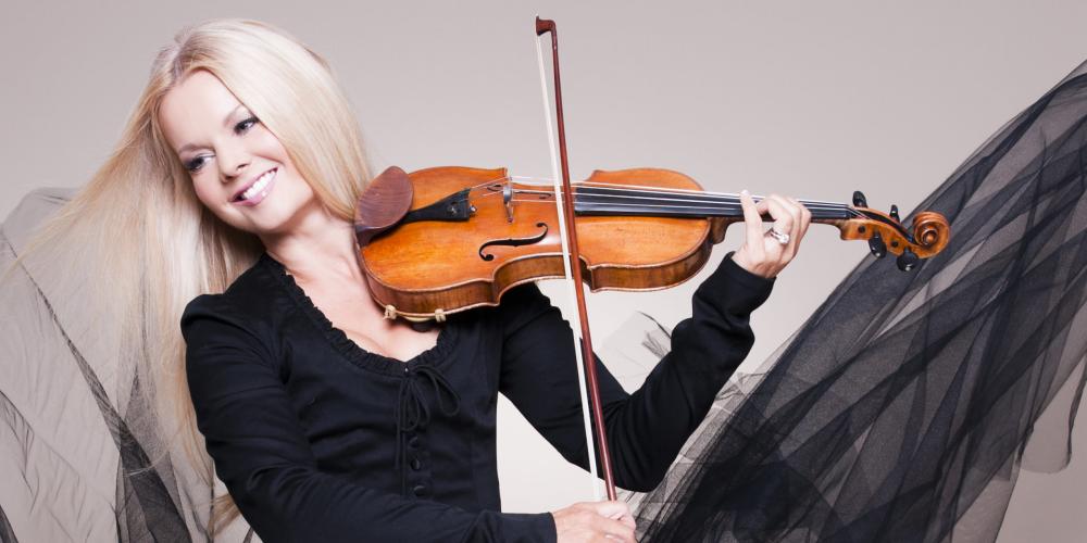 Mairead Nesbitt, wearing a black dress, plays the fiddle 