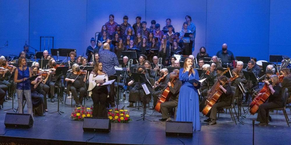 Singer standing in front of orchestra 