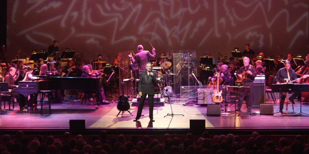 Jack Wright standing in front of orchestra
