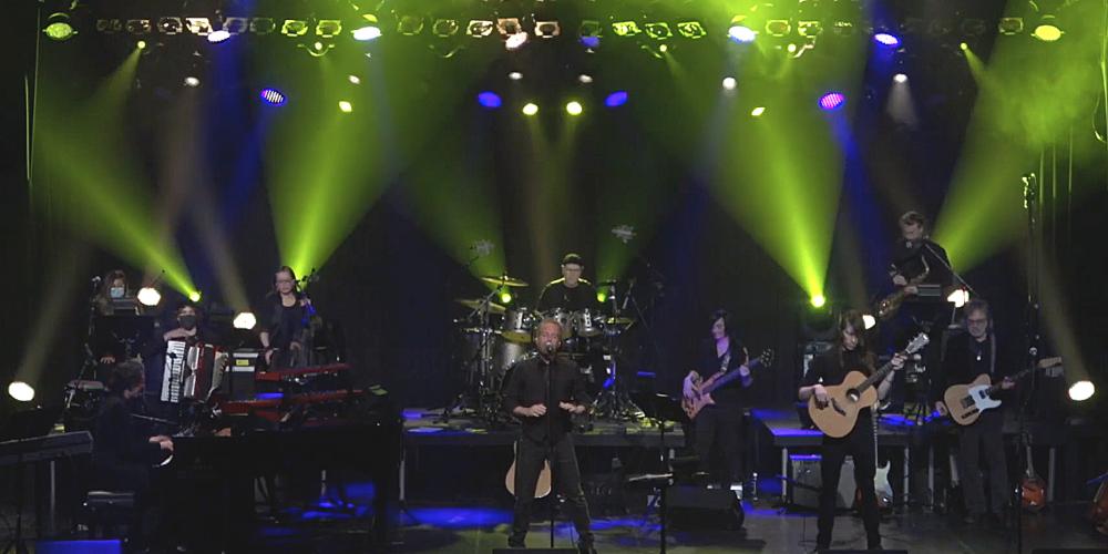 Musicians on stage lit with dramatic green lights