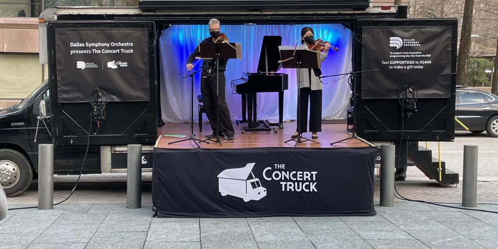 The musicians of the Concert Truck perform outdoors.