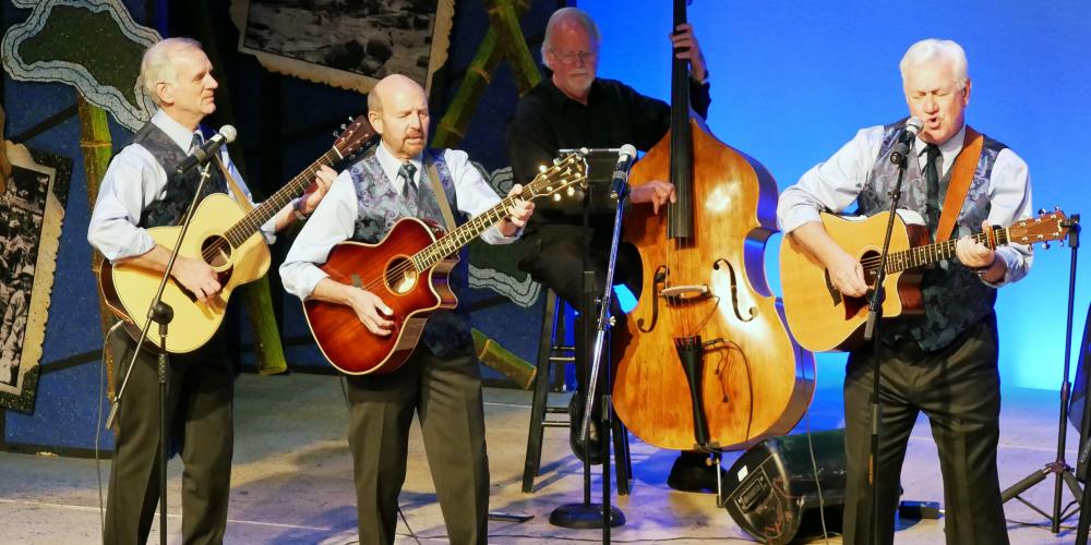 Folk Legacy Trio playing guitar