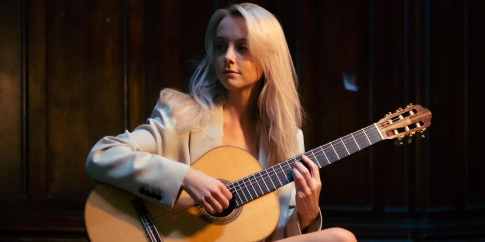 Alexandra Whitingham holding her guitar