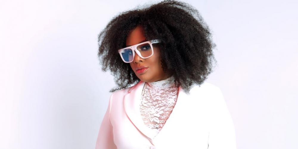 Lalah Hathaway wearing a white suit