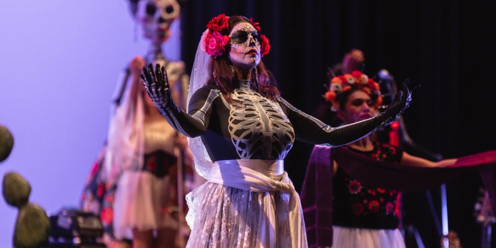 woman with skeleton costume and skirt on with dead makeup 