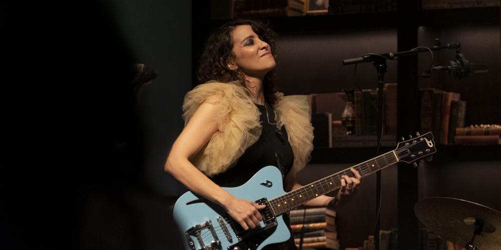 Gaby Moreno playing guitar on stage