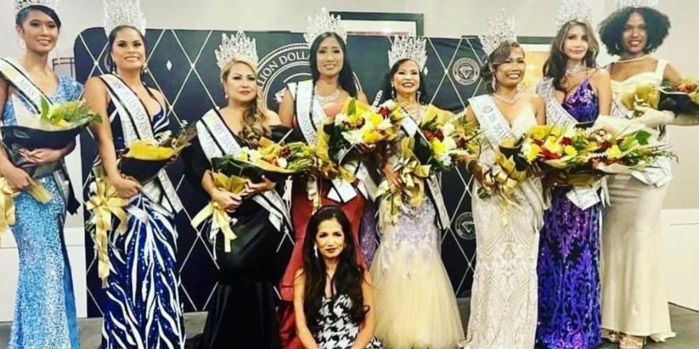 group of women wearing dresses, holding flowers, wearing crowns and looking at the camera smiling