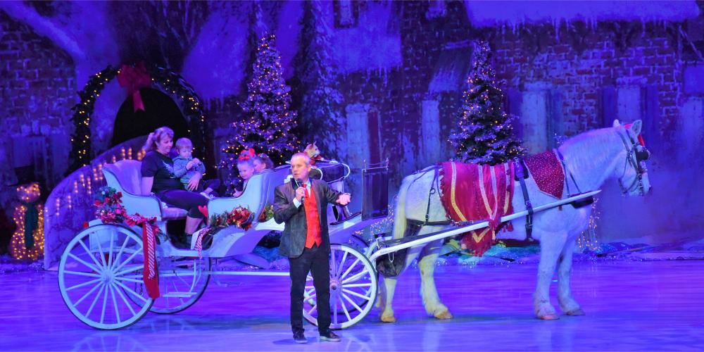 horse and carriage on stage with the host