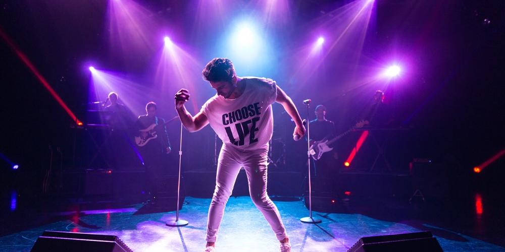 On stage wearing a white outfit