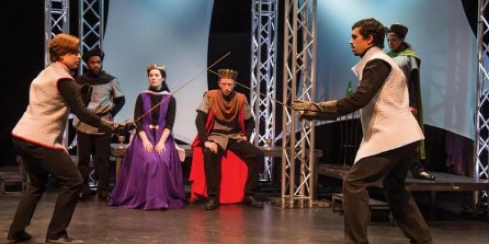 Two men sword fighting on stage