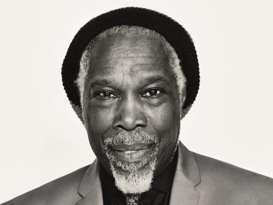 Black and white photo of Billy Ocean wearing a hat