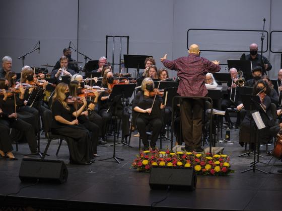 Chandler Symphony Orchestra presents Autumn Classics An orchestra plays on a stage with the conductor in front of them.