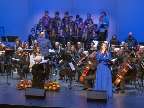 Singer standing in front of orchestra 