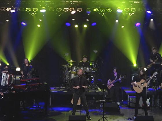 Musicians on stage lit with dramatic green lights