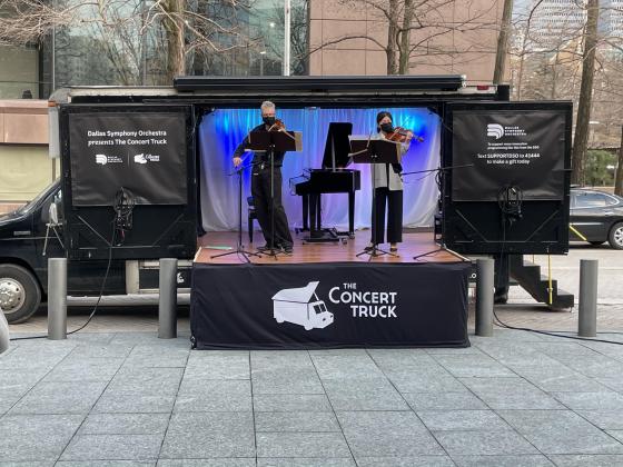 The musicians of the Concert Truck perform outdoors.