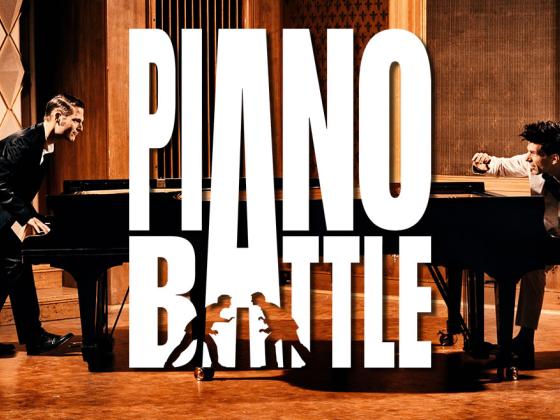 Photograph of Adreas and Paul on stage behind their pianos with the words "Piano Battle" in bold white text.