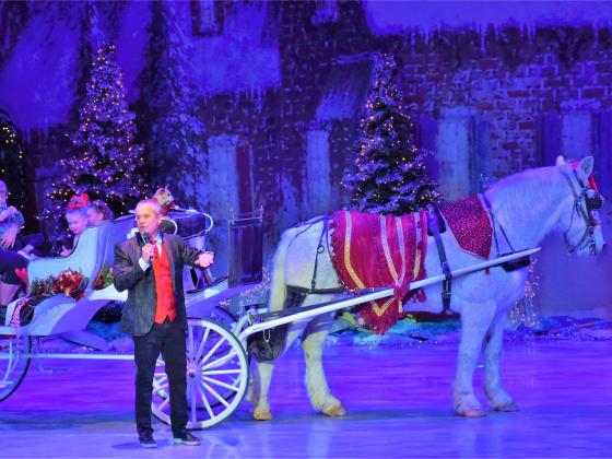 spirit of christmas carriage horse and carriage on stage with the host